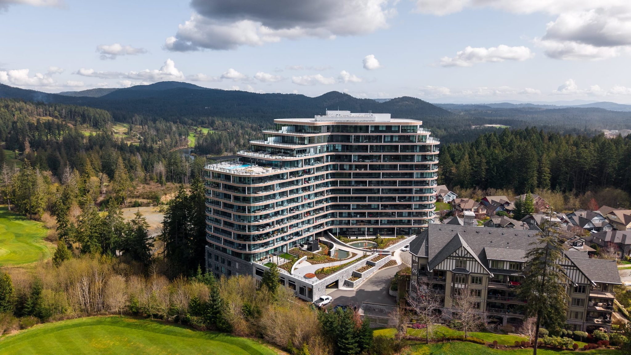 Curved residential tower on the Bear Mountain golf course, shot from the air
