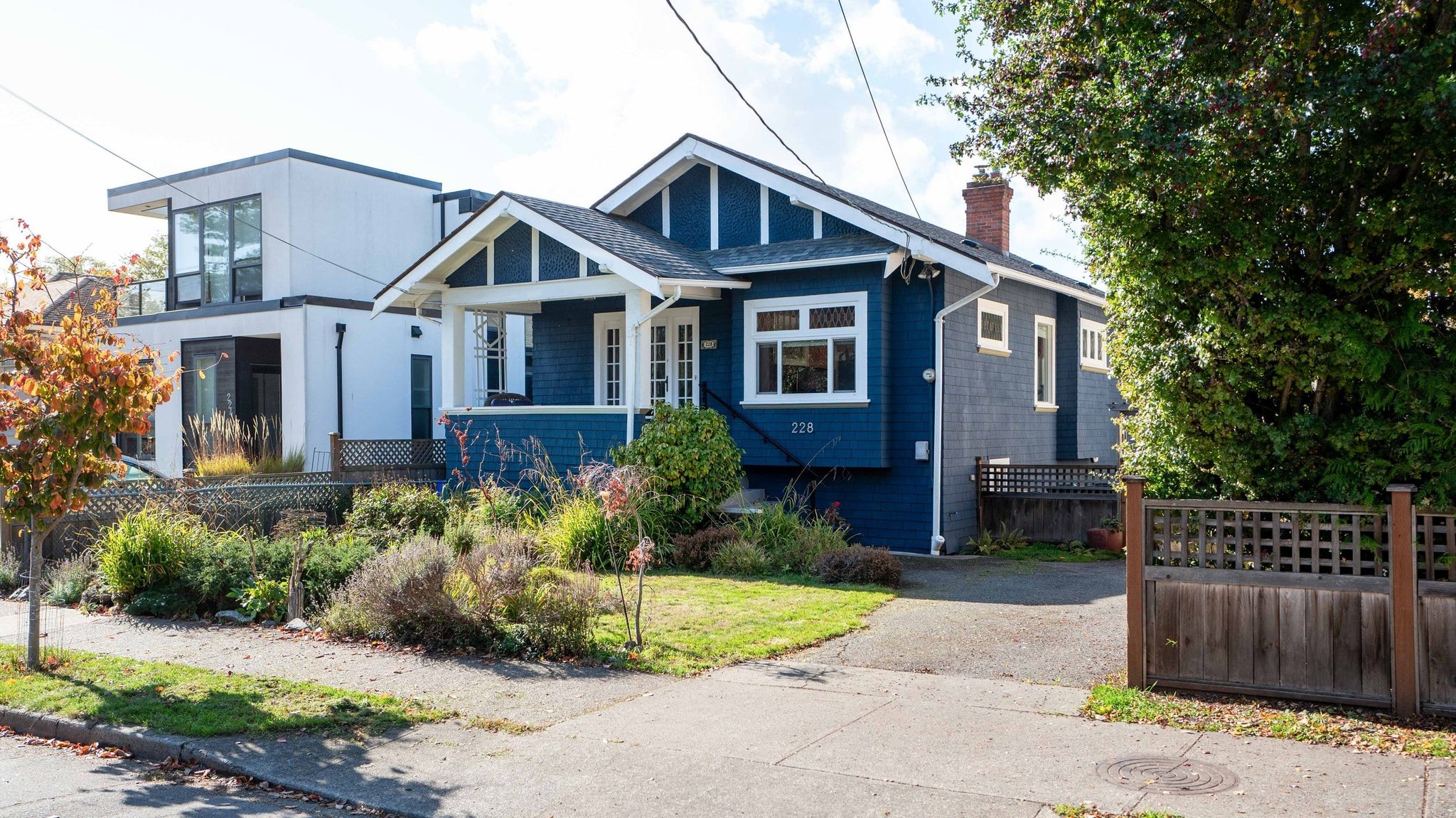 Blue craftsman bungalow exterior on a Victoria BC street
