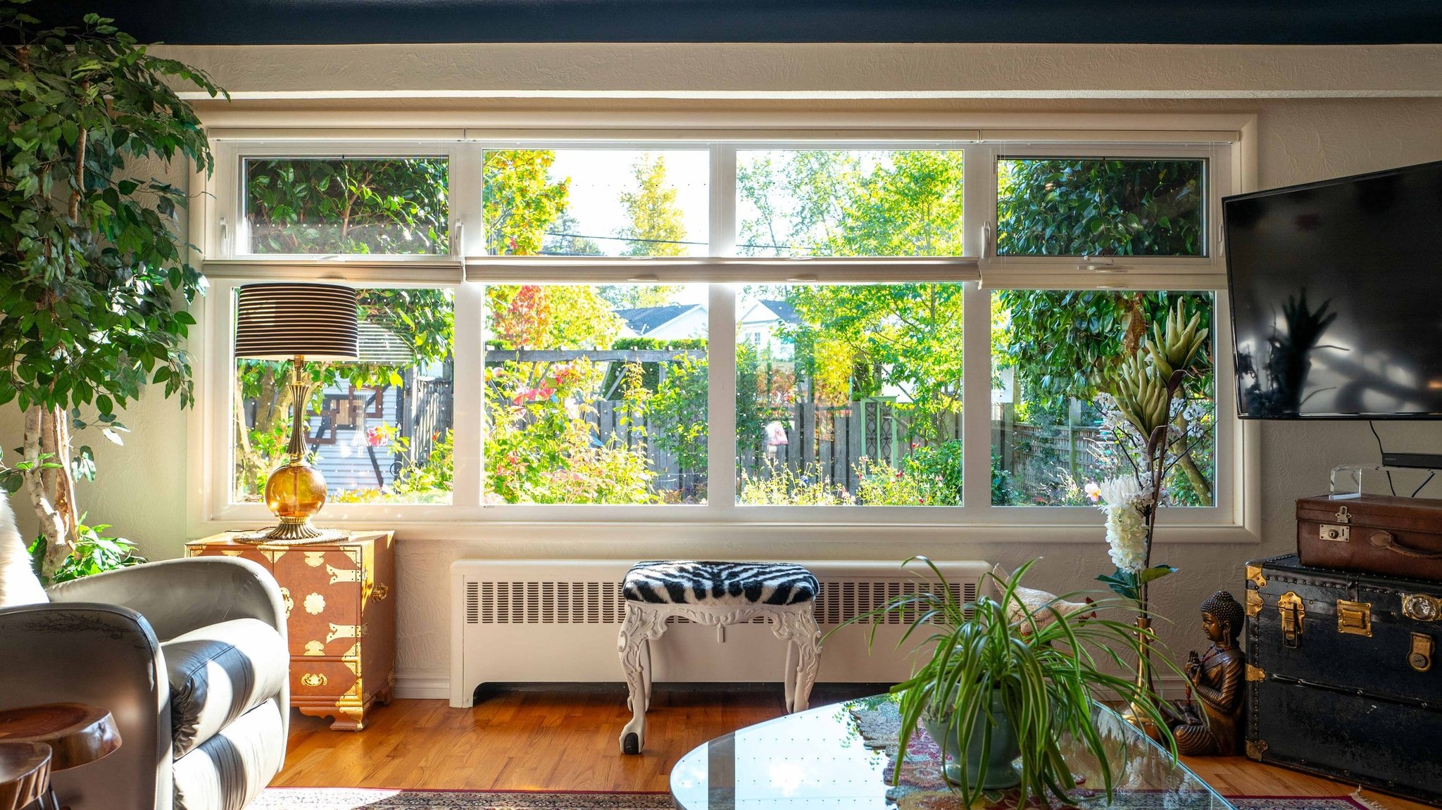 Sunlit living room with garden view and eclectic furnishings