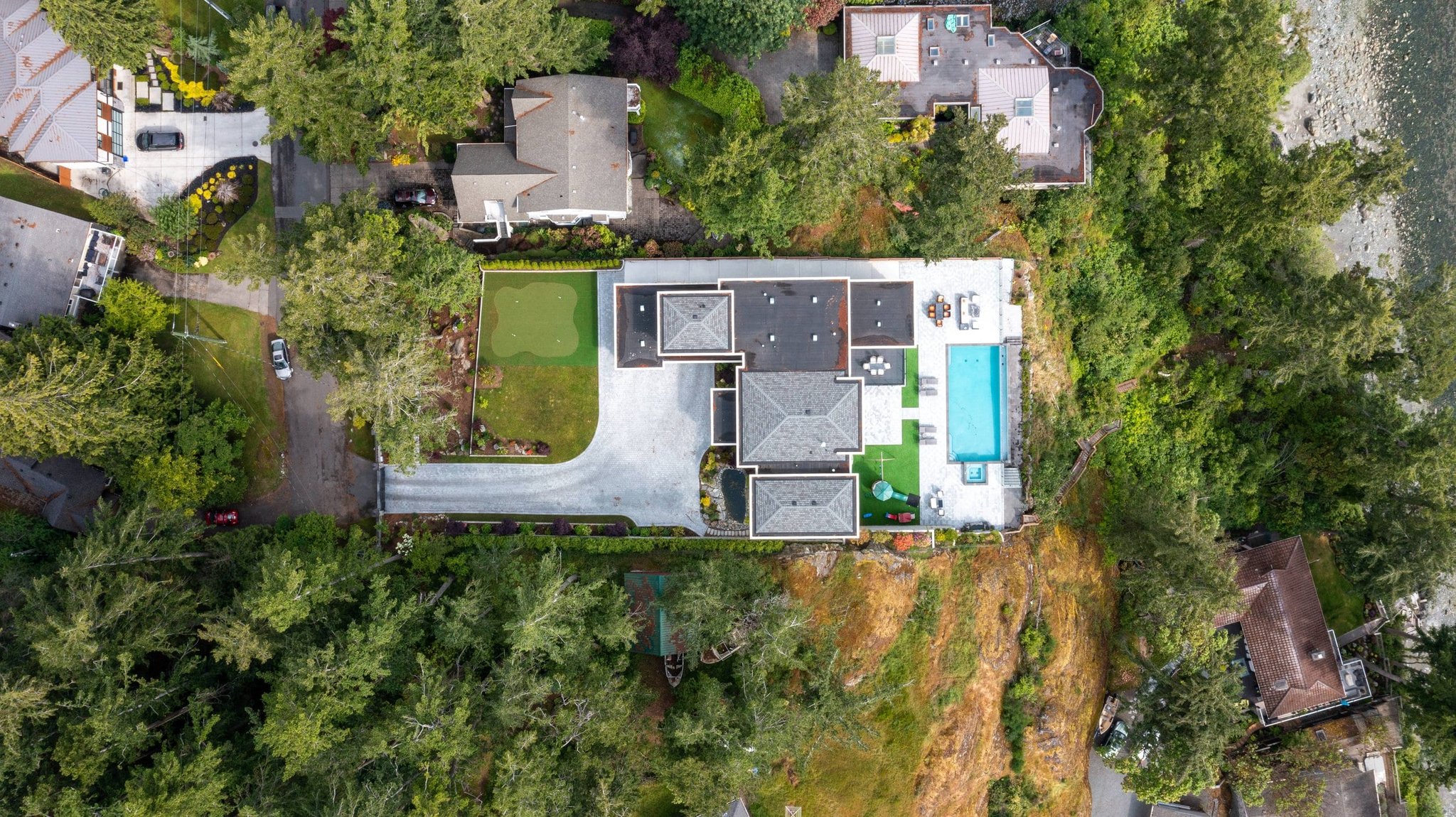 Aerial view of a private Victoria BC estate with pool and putting green