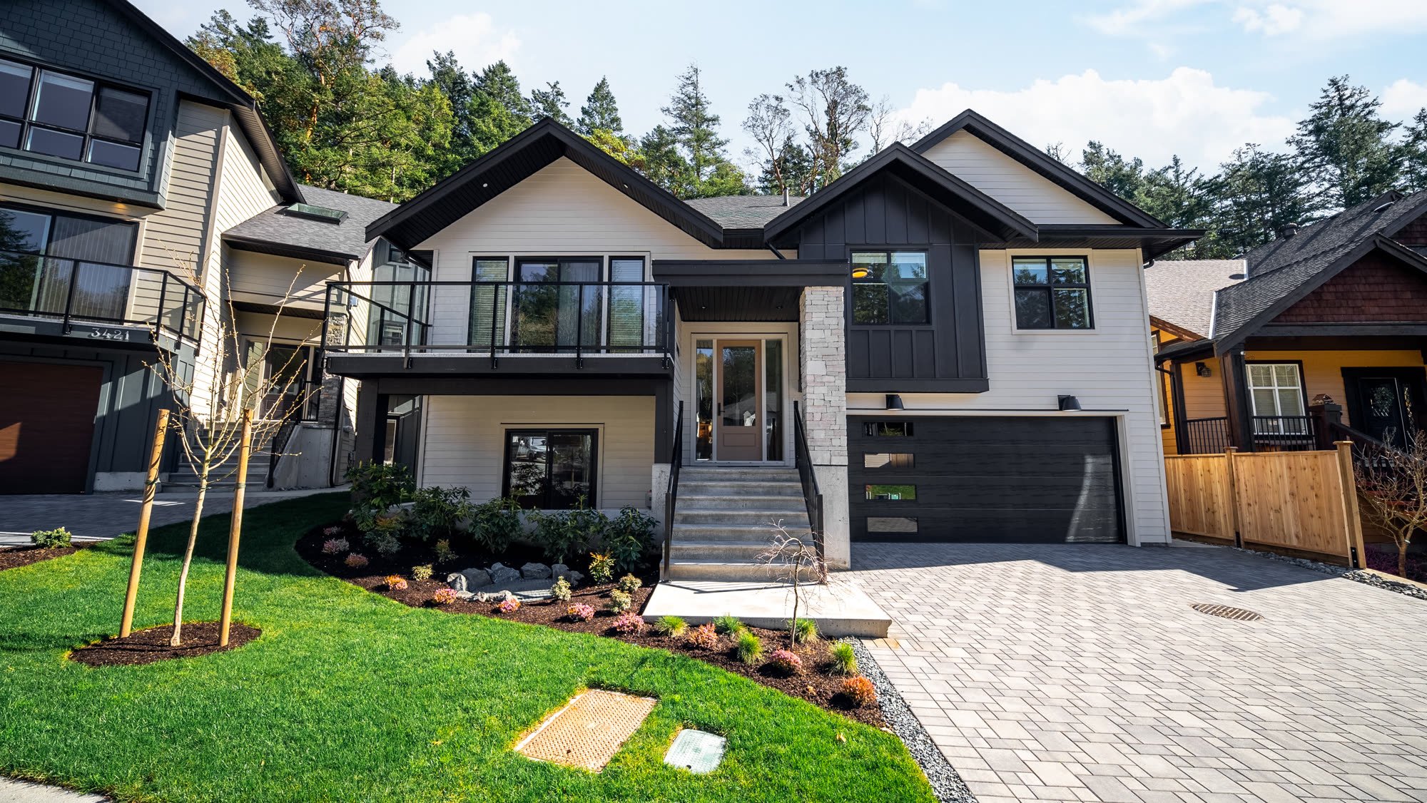 New two-storey family home with landscaped front garden and a paver driveway