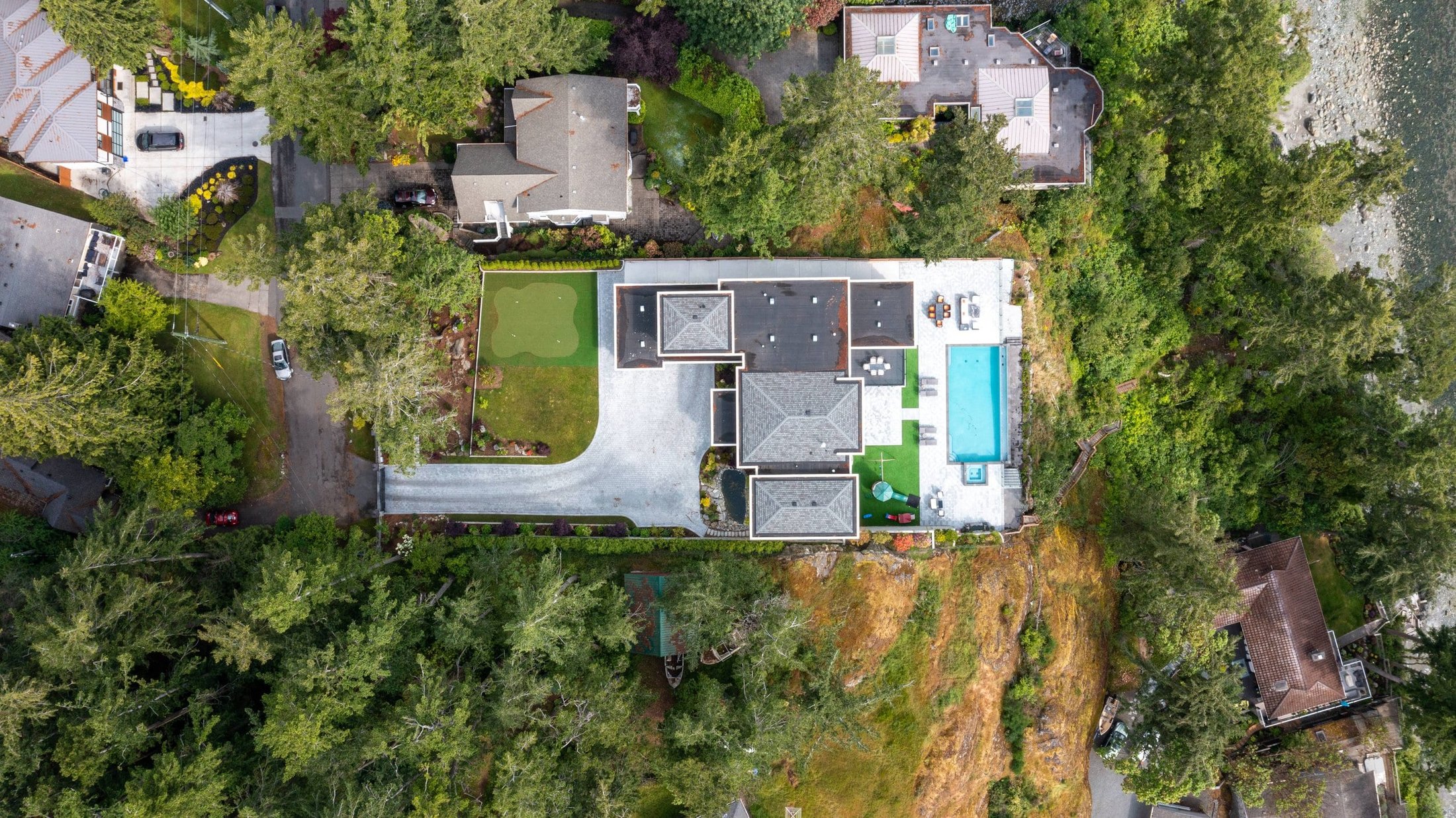 Aerial view of a private Victoria BC estate with pool and putting green